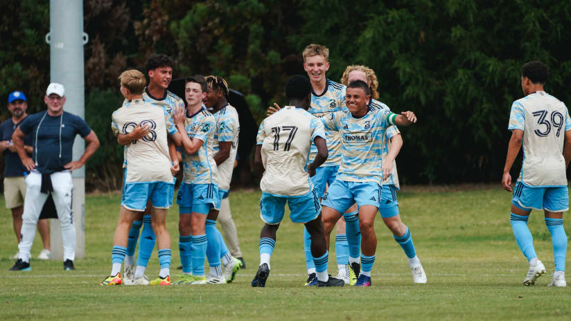 Philadelphia Union players celebrate on the field wearing their 2024 away jersey,